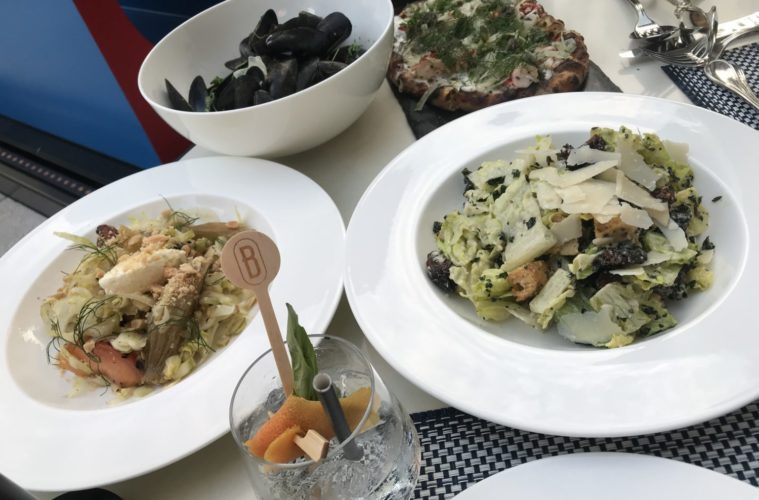 The Art of Outdoor Dining - Le Petit Belvedere 38 Mussels lobster flatbread pêche fennel salad and charred Caesar Michele Stueven