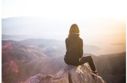 Woman on Mountain watching Sun