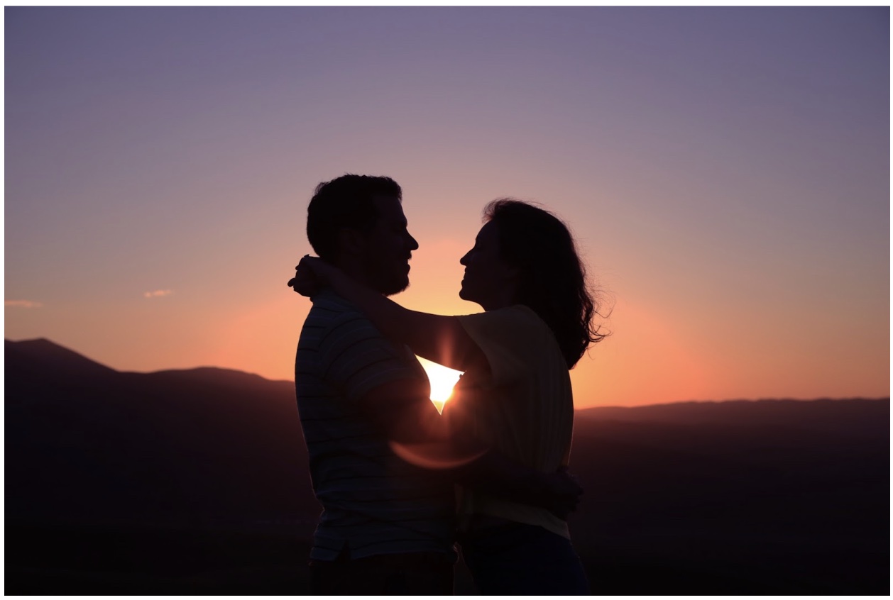 Man and Woman Hugging During Sunset