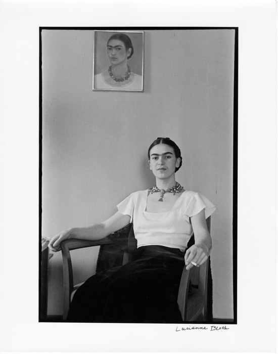 1933 Frida sitting with self portrait Credit Photo by Lucienne Bloch Courtesy Old Stage Studios